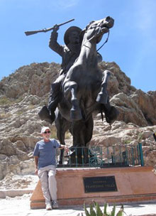 Lee Klein, California Native founder, stands beside a statue of Pancho Villa in the city of Zacatecas